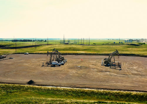 aerial photo of trucks at a well site